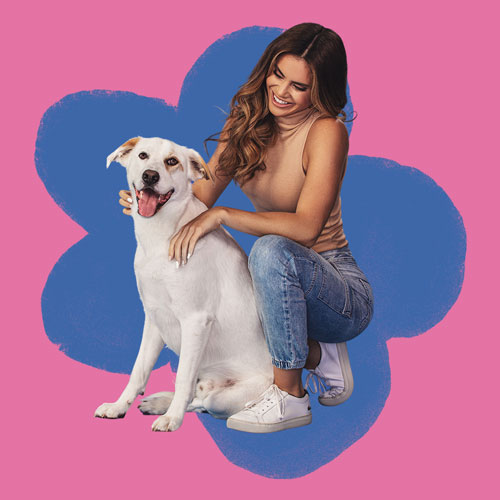 A woman petting a dog